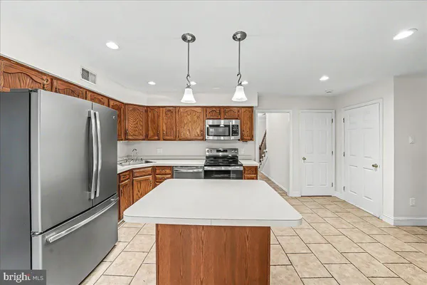 a kitchen with stainless steel appliances a refrigerator sink and cabinets