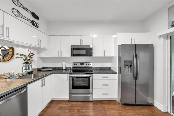 a kitchen with a refrigerator stove and sink