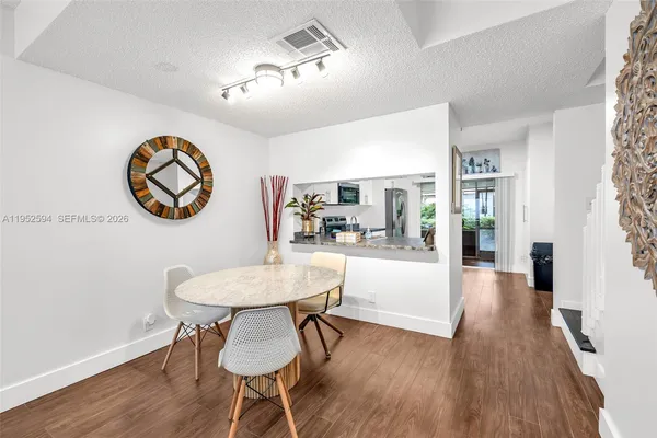 a view of a dining room with furniture and wooden floor