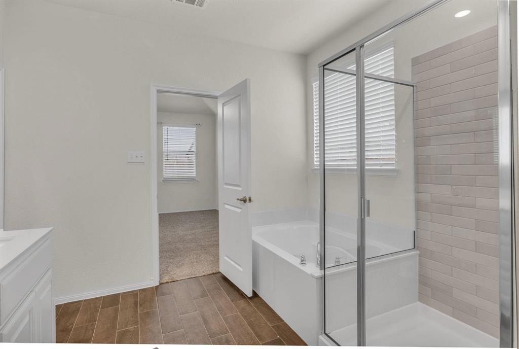 3106 Maverick Drive Forney, TX 75126 - Photo 21 of 32 a bathroom with a bathtub and a shower