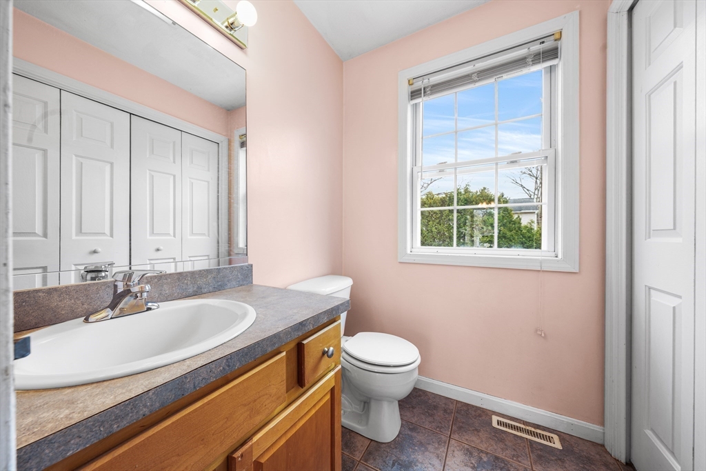 12 Horton Lane Billerica, MA 01821 - Photo 18 of 21 a bathroom with a sink a toilet and a window