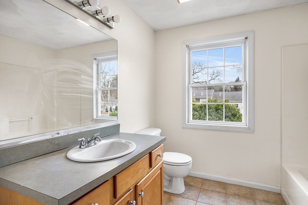 12 Horton Lane Billerica, MA 01821 - Photo 19 of 21 a bathroom with a sink a toilet and a window