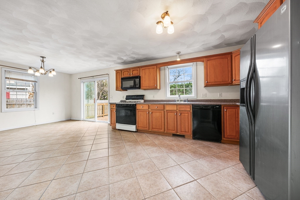 12 Horton Lane Billerica, MA 01821 - Photo 4 of 21 a kitchen with stainless steel appliances granite countertop a stove top oven a sink dishwasher and a refrigerator