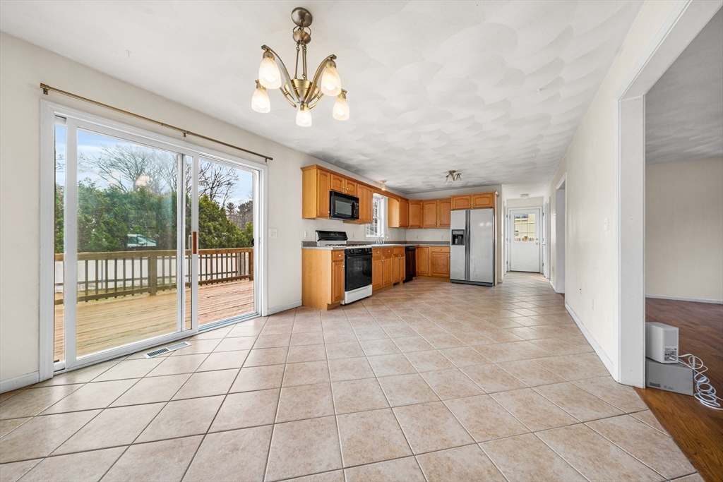 12 Horton Lane Billerica, MA 01821 - Photo 7 of 21 a view of a kitchen with furniture and an empty room