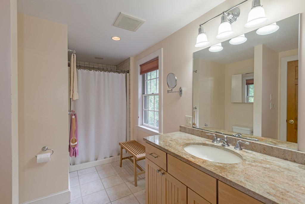 72 Little Neck Road Ipswich, MA 01938 - Photo 18 of 20 a bathroom with a granite countertop sink a toilet and a mirror