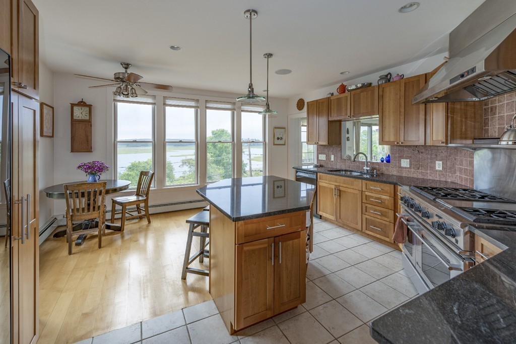 72 Little Neck Road Ipswich, MA 01938 - Photo 6 of 20 a kitchen with sink cabinets and dining table view