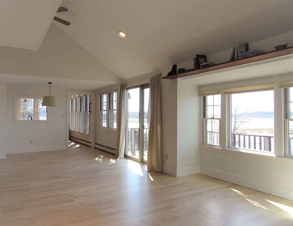 72 Little Neck Road Ipswich, MA 01938 - Photo 9 of 20 a view of an empty room with glass door and windows