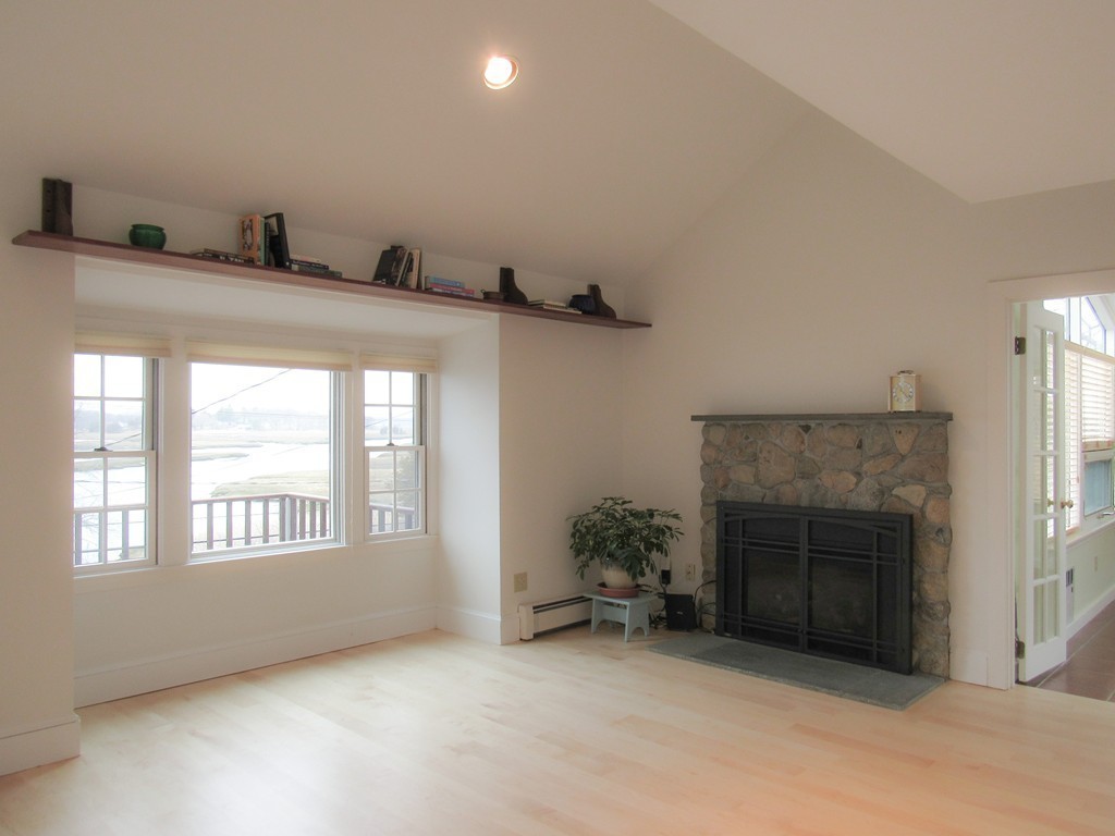 72 Little Neck Road Ipswich, MA 01938 - Photo 10 of 20 a view of an empty room with a fireplace and a window