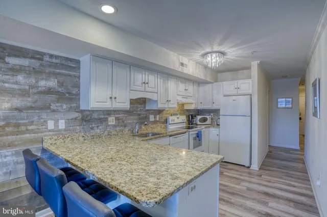 a kitchen with a sink cabinets and window