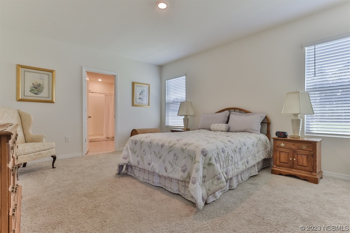 302 Sunset View Drive Edgewater, FL 32141 - Photo 19 of 45 a bedroom with a bed and chair
