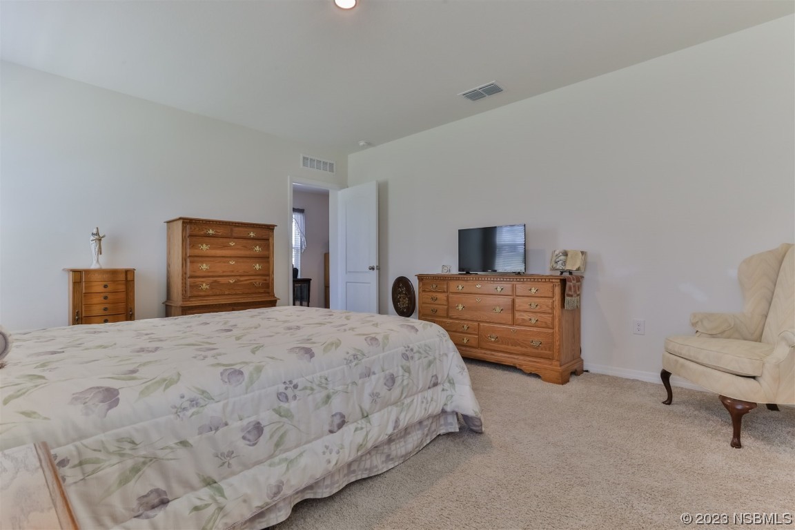 302 Sunset View Drive Edgewater, FL 32141 - Photo 21 of 45 a bedroom with a bed and furniture