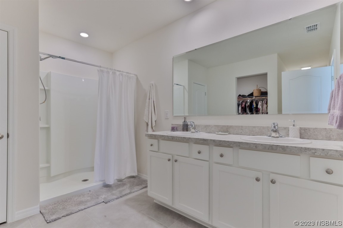 302 Sunset View Drive Edgewater, FL 32141 - Photo 22 of 45 a bathroom with a double vanity sink and mirror