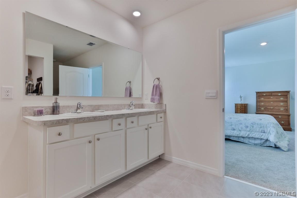 302 Sunset View Drive Edgewater, FL 32141 - Photo 23 of 45 a en suite bathroom with 2 sink flowerpot and a mirror