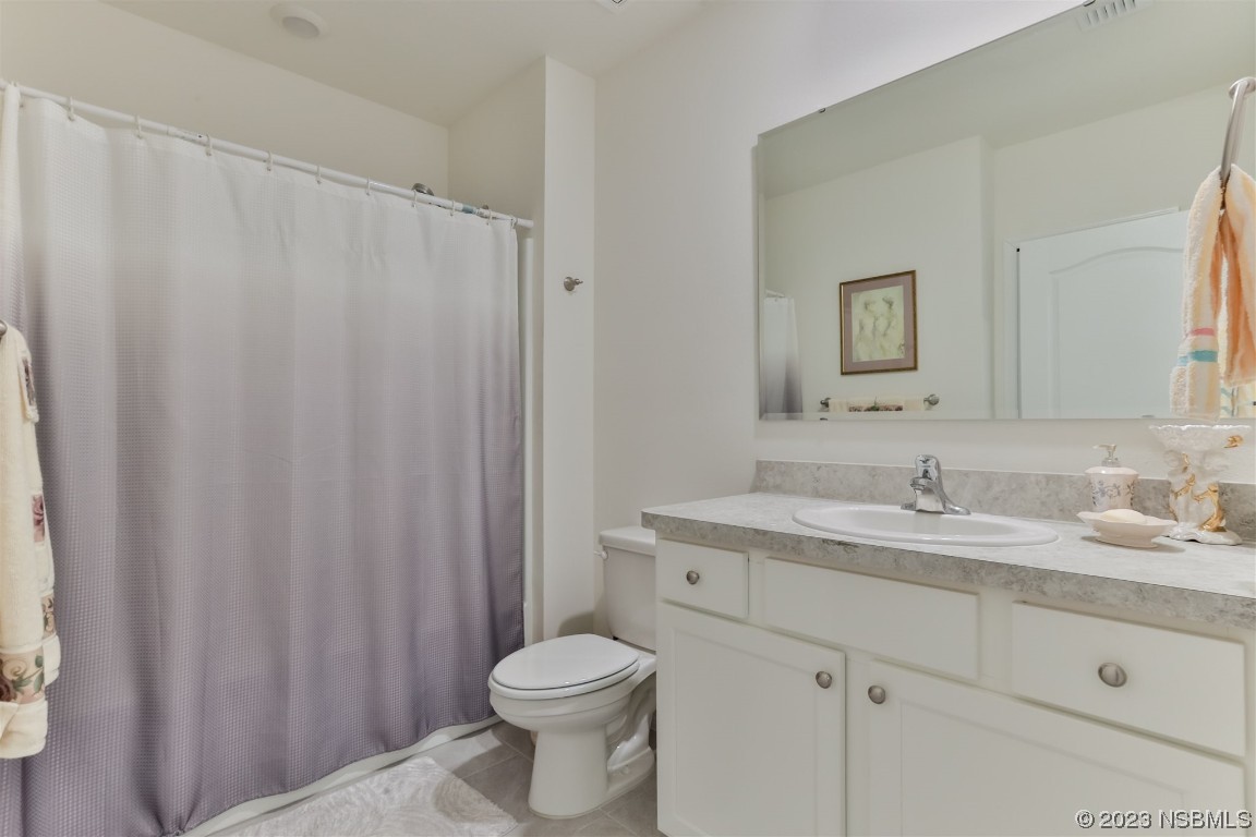 302 Sunset View Drive Edgewater, FL 32141 - Photo 26 of 45 a bathroom with a granite countertop sink and a toilet