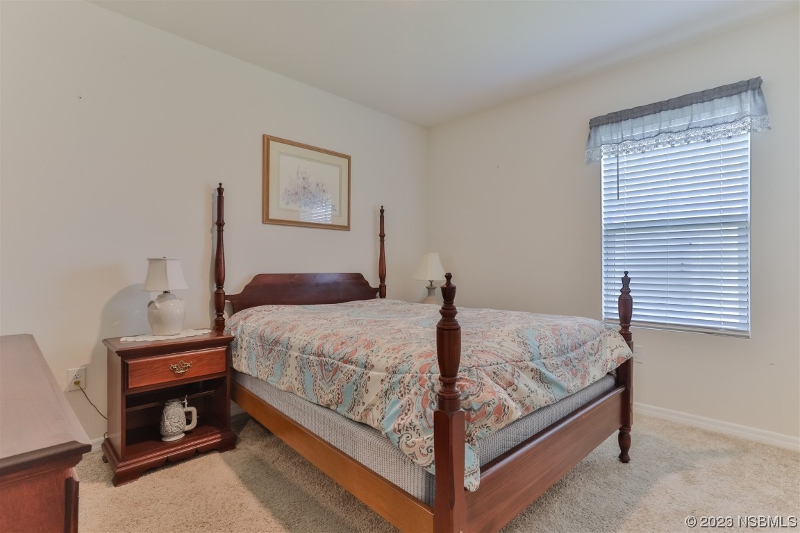 302 Sunset View Drive Edgewater, FL 32141 - Photo 27 of 45 a bedroom with a bed and a window