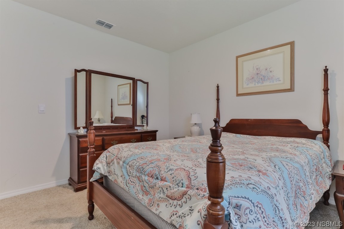 302 Sunset View Drive Edgewater, FL 32141 - Photo 28 of 45 a bedroom with a bed and a mirror