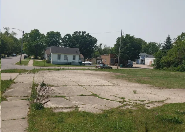 a backyard of a house with barbeque oven and outdoor seating