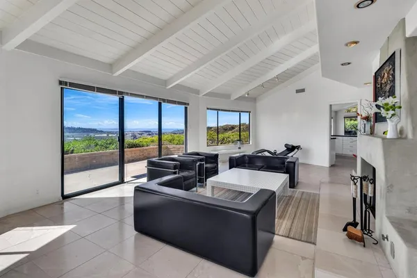 a living room with furniture tv and a large window