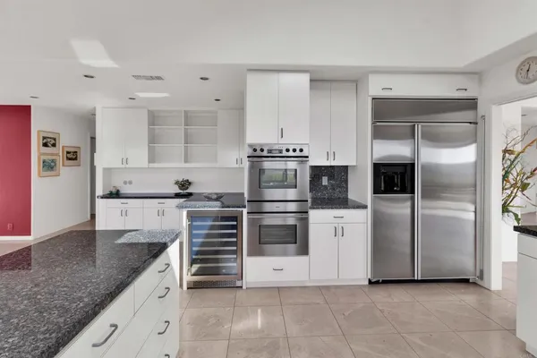 a kitchen with cabinets and stainless steel appliances