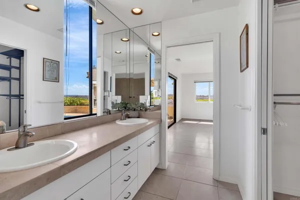 a bathroom with a double vanity sink and a mirror