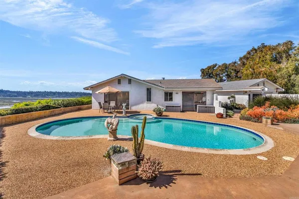 a swimming pool with outdoor seating and yard