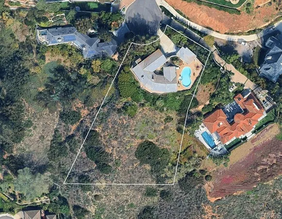 an aerial view of a house with a swimming pool