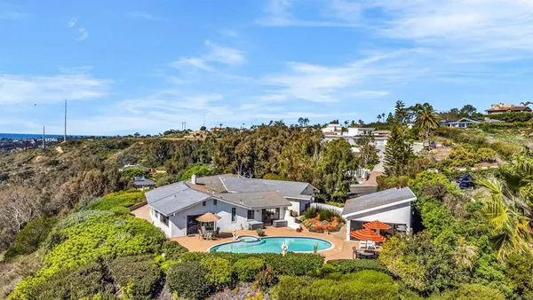 an aerial view of a house with a garden