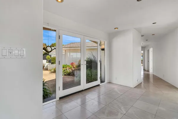 a view of an entryway with wooden floor