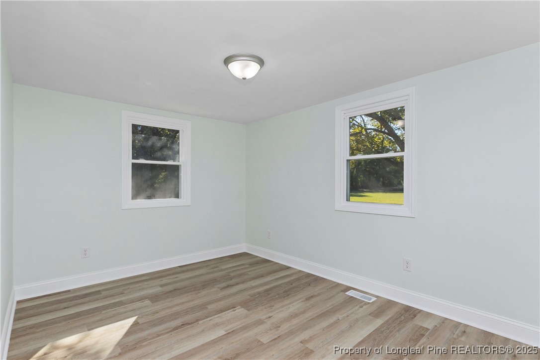 1340 George Perry Lee Road Dunn, NC 28334 - Photo 25 of 31 a view of empty room with window and wooden floor