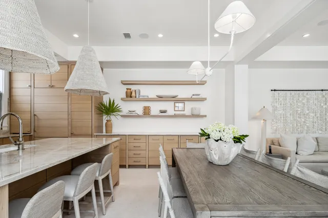 a kitchen with a table chairs sink and cabinets