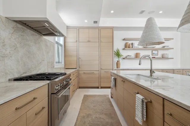 a kitchen with stainless steel appliances a sink and a refrigerator