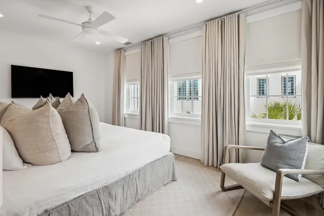 a large bed sitting in a room and with table chair