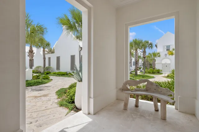 a view of a porch with furniture and floor to ceiling window