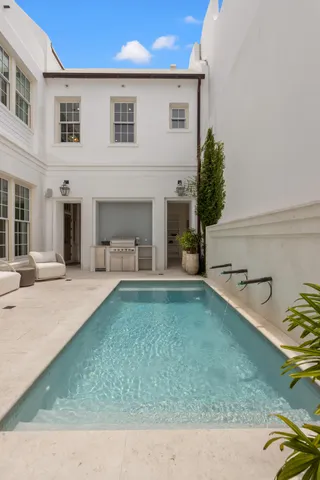 a view of a house with backyard and sitting area