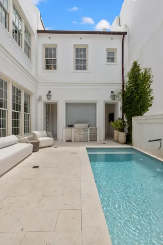 a view of a house with backyard and sitting area