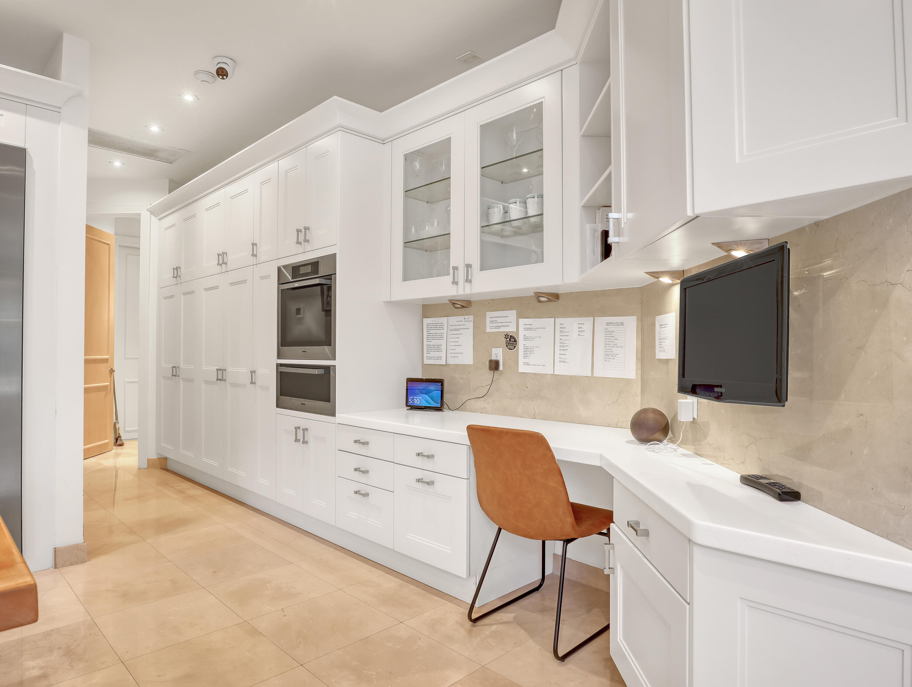 7207 Valencia Drive Boca Raton, FL 33433 - Photo 12 of 32 a kitchen that has a lot of cabinets a sink and a refrigerator in it