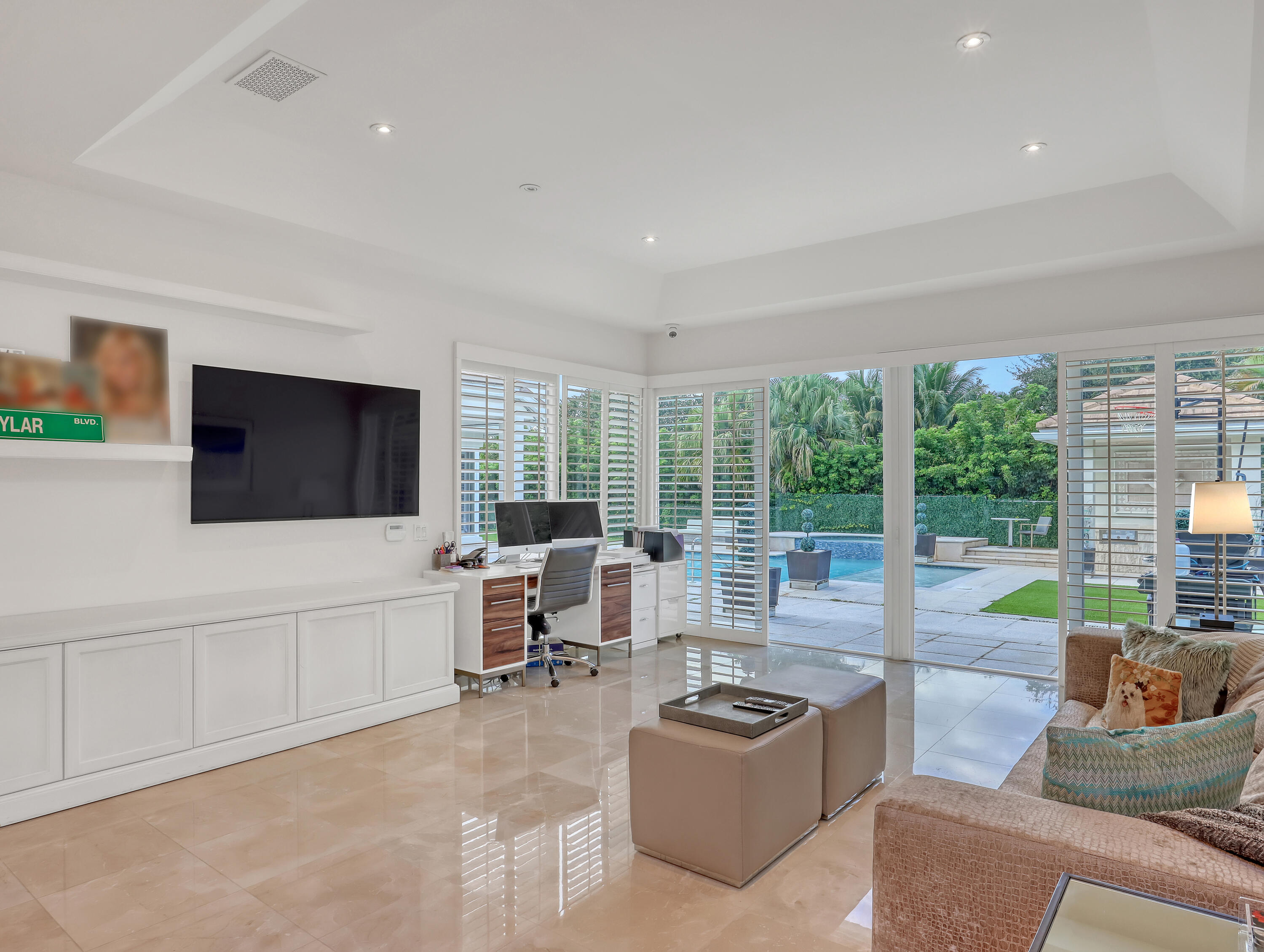 7207 Valencia Drive Boca Raton, FL 33433 - Photo 15 of 32 a living room with furniture a flat screen tv and a floor to ceiling window
