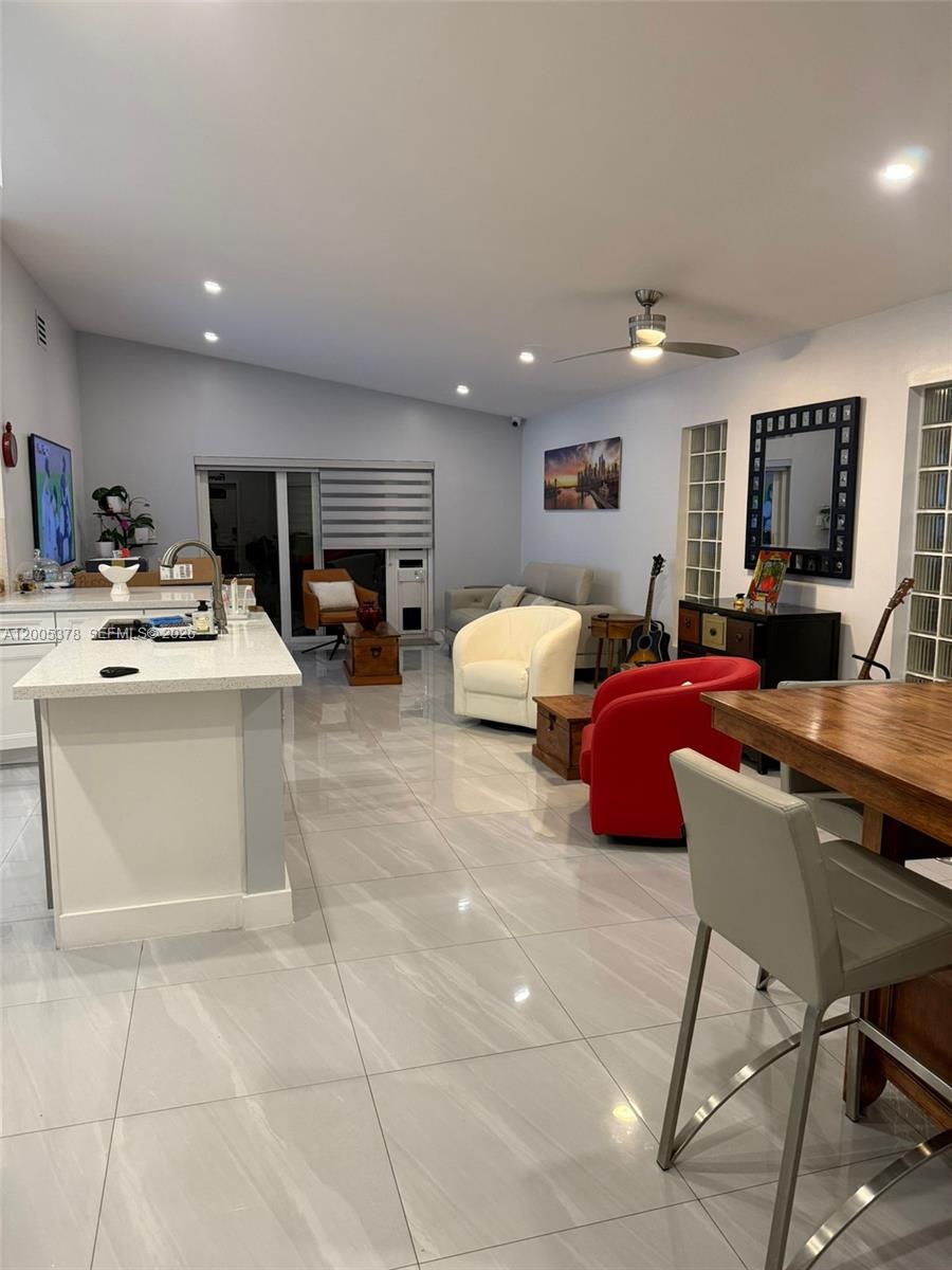 16314 Southwest 97th Street Miami, FL 33196 - Photo 11 of 41 a living room with furniture and a flat screen tv