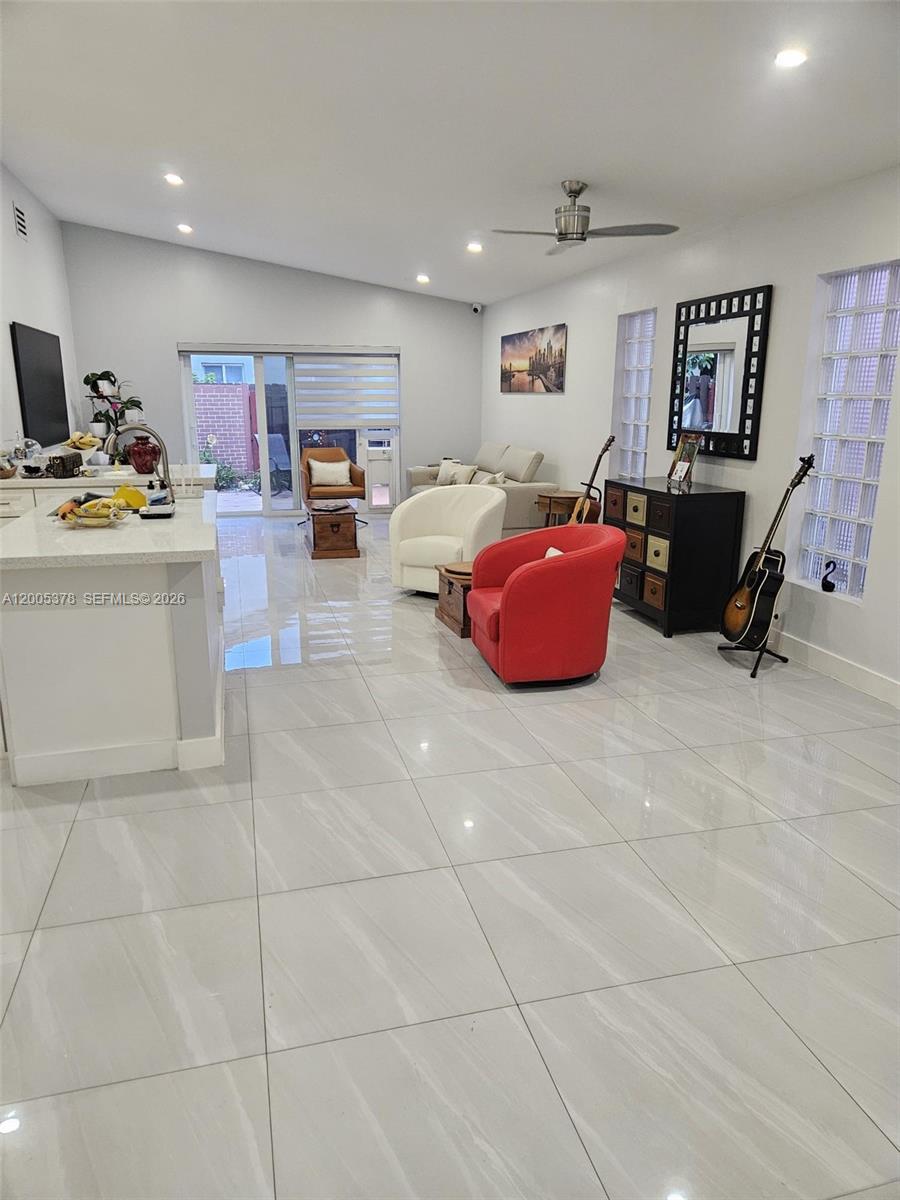 16314 Southwest 97th Street Miami, FL 33196 - Photo 12 of 41 a living room with furniture and a flat screen tv