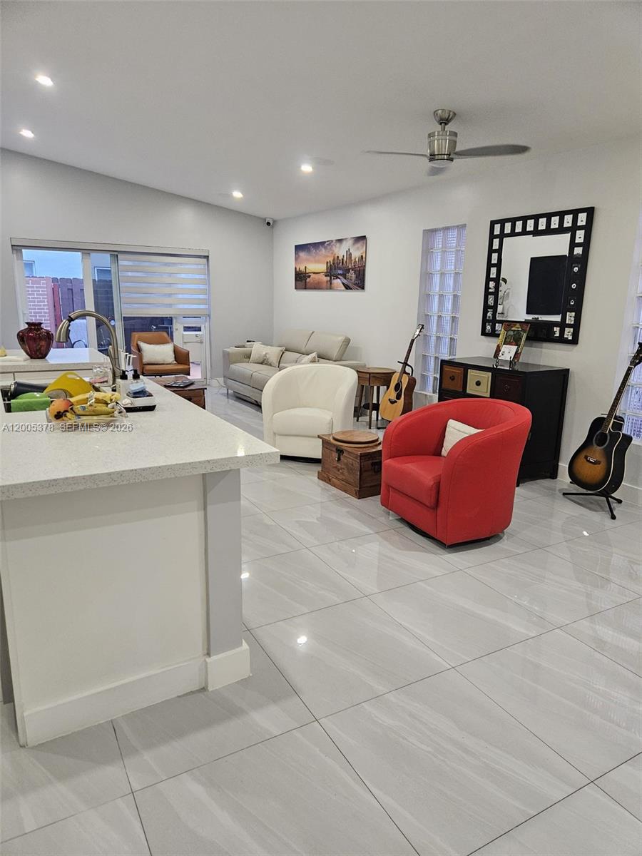 16314 Southwest 97th Street Miami, FL 33196 - Photo 13 of 41 a view of living room with furniture and a flat screen tv