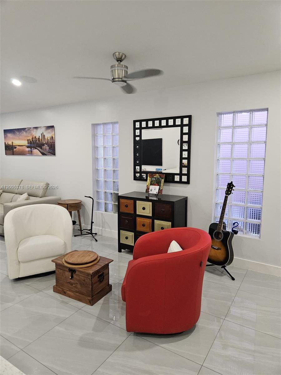 16314 Southwest 97th Street Miami, FL 33196 - Photo 14 of 41 a bedroom with furniture a flat screen tv and a window