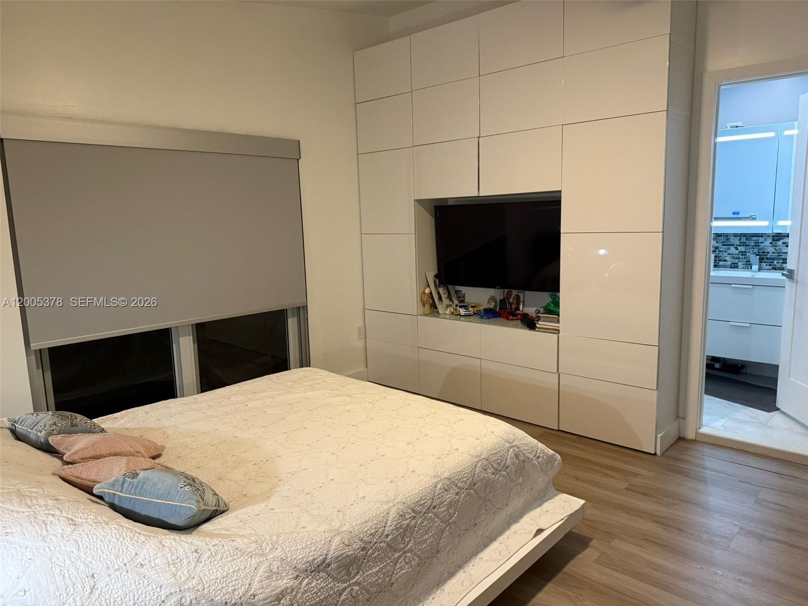 16314 Southwest 97th Street Miami, FL 33196 - Photo 17 of 41 a bedroom with a bed and a flat screen tv