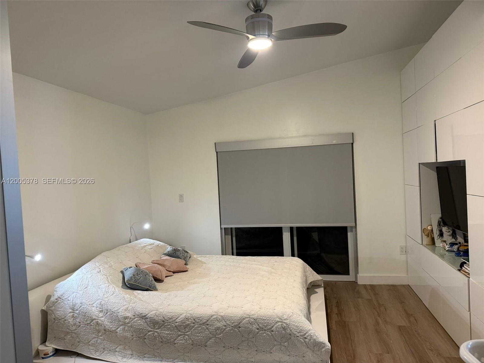 16314 Southwest 97th Street Miami, FL 33196 - Photo 18 of 41 a bedroom with a bed and a flat screen tv