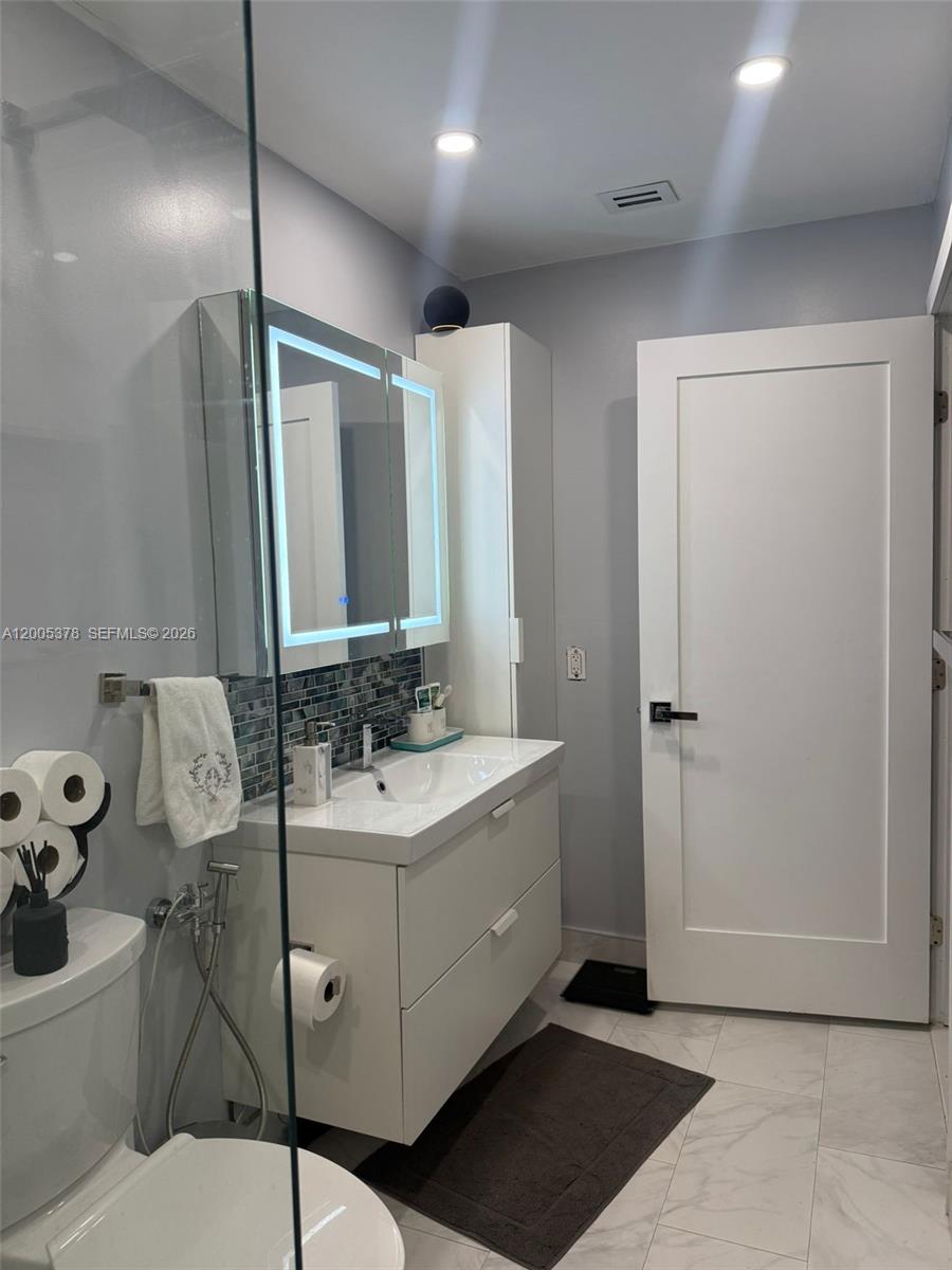 16314 Southwest 97th Street Miami, FL 33196 - Photo 19 of 41 a bathroom with a sink and mirror