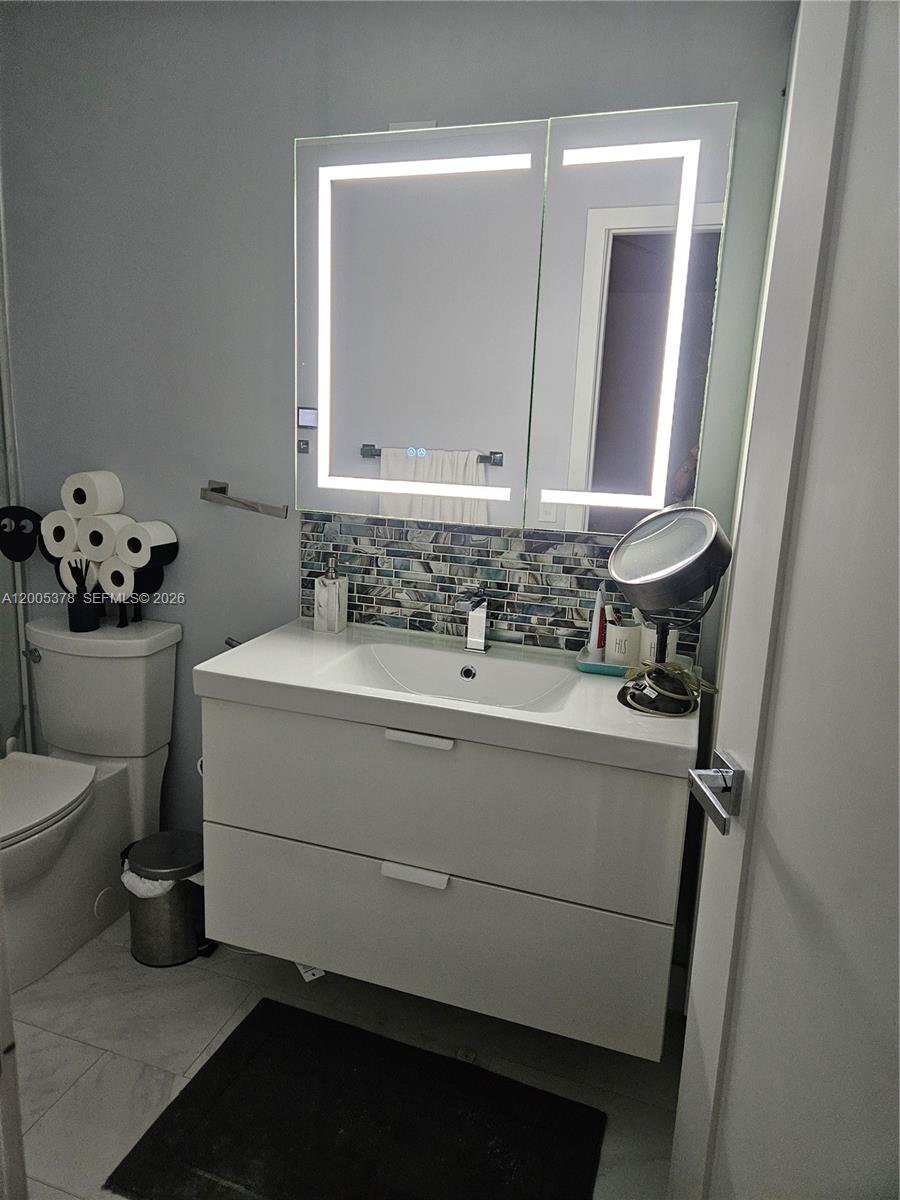 16314 Southwest 97th Street Miami, FL 33196 - Photo 20 of 41 a bathroom with a sink toilet and mirror