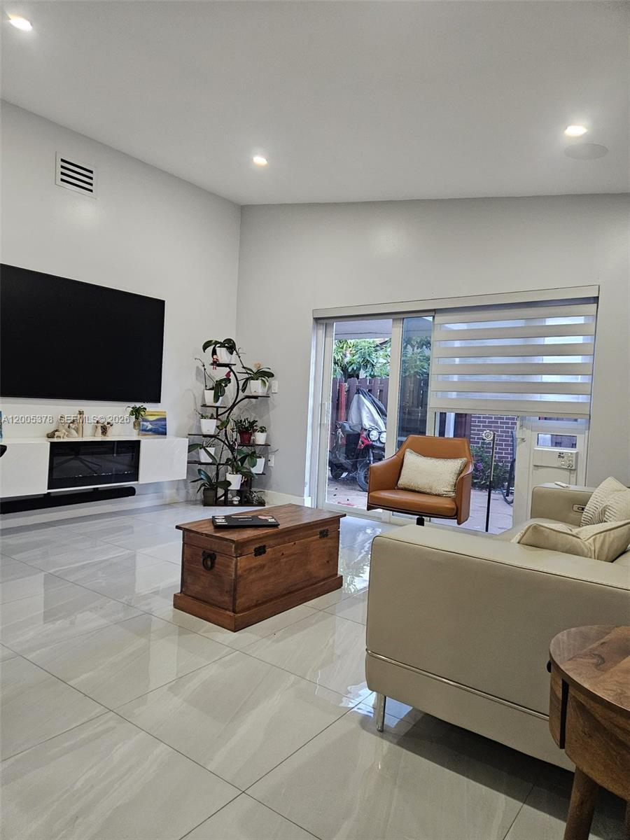 16314 Southwest 97th Street Miami, FL 33196 - Photo 2 of 41 a living room with furniture and a flat screen tv