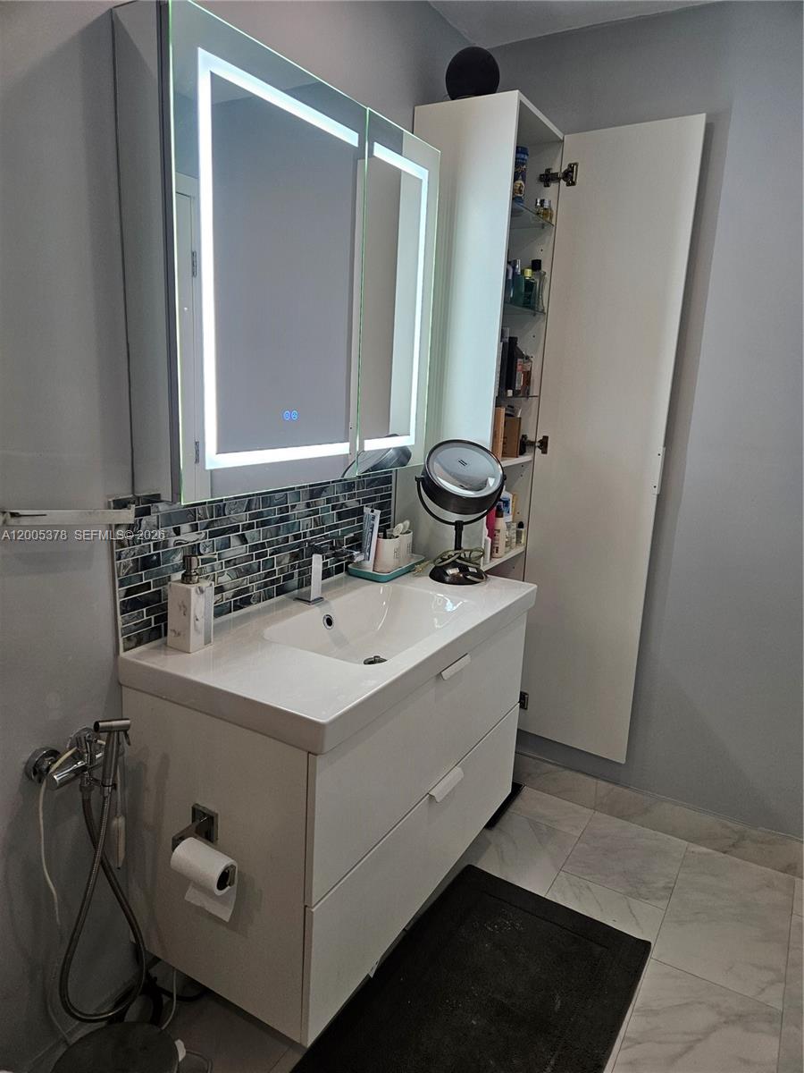 16314 Southwest 97th Street Miami, FL 33196 - Photo 22 of 41 a bathroom with a sink and a mirror