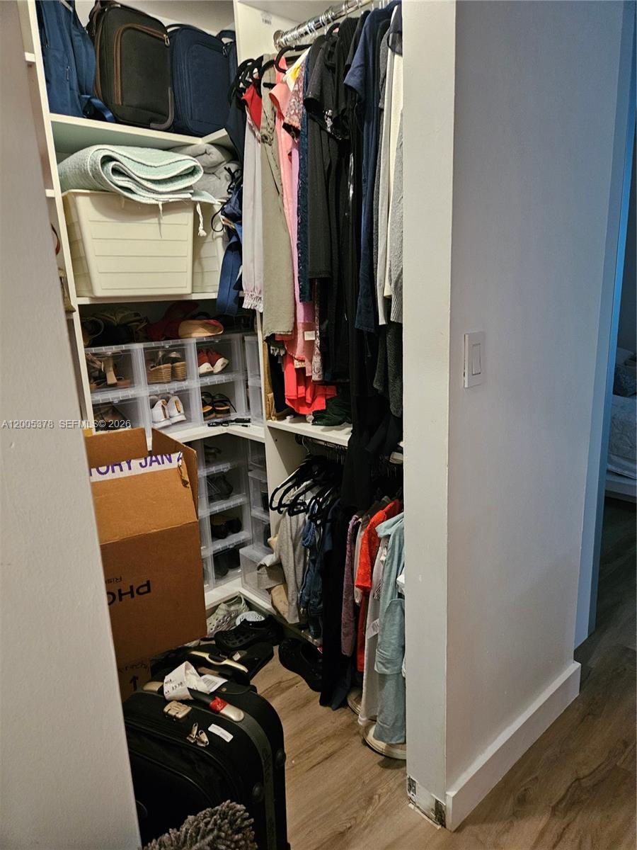 16314 Southwest 97th Street Miami, FL 33196 - Photo 25 of 41 a view of walk in closet with clothes and shoes