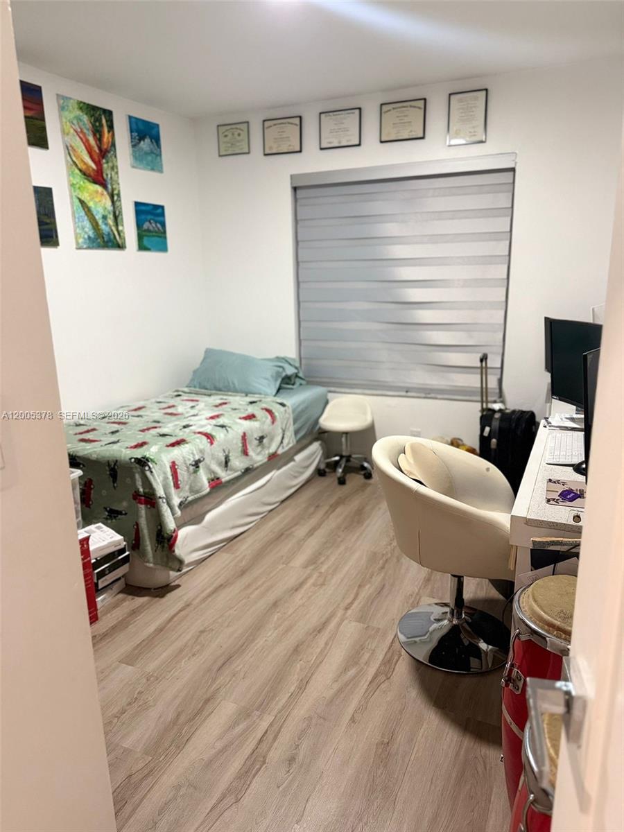 16314 Southwest 97th Street Miami, FL 33196 - Photo 30 of 41 a bedroom with a bed and a workspace