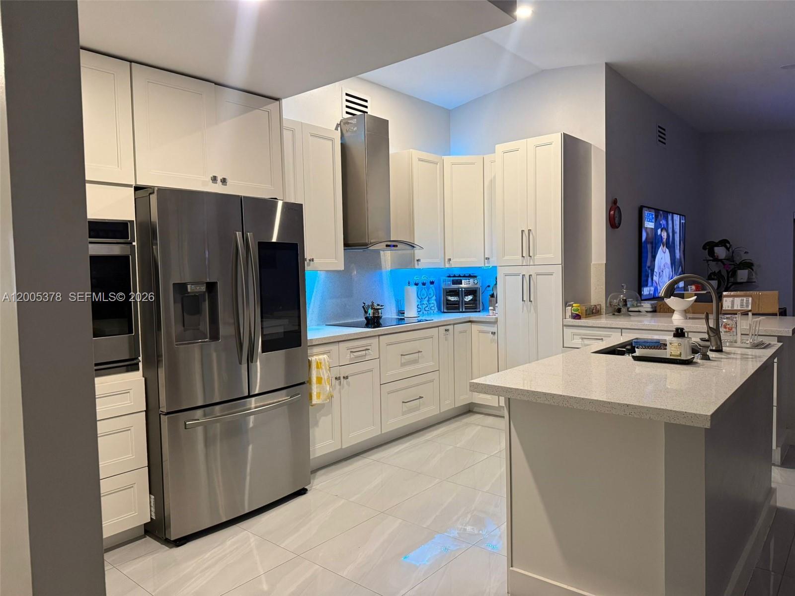 16314 Southwest 97th Street Miami, FL 33196 - Photo 3 of 41 a kitchen with stainless steel appliances a refrigerator sink and cabinets